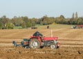 Two old vintage red tractors ploughing Royalty Free Stock Photo