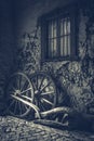 Two old wagon wheels near an ancient wall Royalty Free Stock Photo