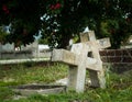 Two old and weathered christian gravestones leaning together as sign of eternal love