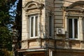 Two old white windows on the brown concrete wall Royalty Free Stock Photo