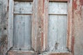 Two old windows in the destroyed rural house in wooden old cracked red and white painted Royalty Free Stock Photo
