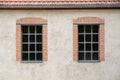 Two windows on a grey plaster wall Royalty Free Stock Photo