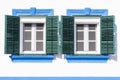 Two old windows with green wood shutters Royalty Free Stock Photo