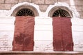 Two old windows with orange shutters Royalty Free Stock Photo