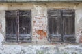 Two old closed windows with wooden shutters in a ruin Royalty Free Stock Photo