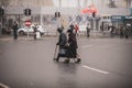 Two old women illegally cross the road in the middle of a crossroad Royalty Free Stock Photo