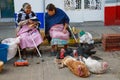 Two old women at the mexico market selling turkey