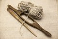 Two old wooden spindle with a ball of wool thread for the manufacture of woolen threads on a tissue background