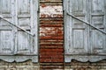 Two old wooden white windows were destroyed by time. Brick wall Royalty Free Stock Photo