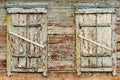 Two old wooden windows with closed shutters Royalty Free Stock Photo