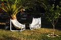 Two armchairs in the garden under the trees