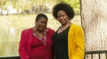 Two Older Black Women Outdoor Portrait Red Yellow