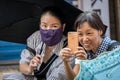 Two older Chinese women taking selfie with a smartphone Royalty Free Stock Photo