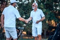 Friendship. Two older men stand on a golf course and talk Royalty Free Stock Photo
