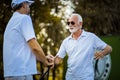 Older men stand on a golf course and talk Royalty Free Stock Photo