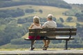 Two older people sitting on a bench Royalty Free Stock Photo