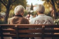 Two older people sitting on a bench in a park, AI Royalty Free Stock Photo