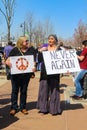 Two older women in bohemian dress with peace sign and protest sign at March for our Lives rally in Tulsa Oklahoma USA 3 24 2018