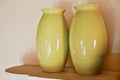 Two olive green vases cottage shelf Royalty Free Stock Photo