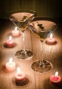 Two olive martini cocktails in the candlelight