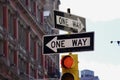 Two One Way Signs over a red traffic signal. New York, NY, USA. April 4, 2015. Royalty Free Stock Photo