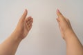 Two open empty female hands with palms up, holding something, isolated on white background Royalty Free Stock Photo