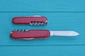 two open folding knives multitools with red handles with gray blades Royalty Free Stock Photo