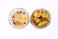 Two open glass jars with pickled cucumbers, isolated, top view. Pickles, banner with a copypace. Snacks.