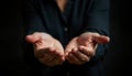 Two open hands outstretched. Empty palms facing forward. Dark background. Concepts of giving, receiving. Possible scenarios Royalty Free Stock Photo