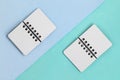Two open paper notebooks on a diagonal colored backround. Top flat lay view with blue green pastel background Royalty Free Stock Photo