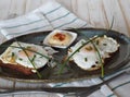 Two open sandwiches with dark rye bread with cheese, fried egg and green onions on a wooden white table. Healthy natural breakfast Royalty Free Stock Photo