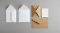 Two open white envelopes and two closed brown envelopes with a small textured card on a grey background Royalty Free Stock Photo