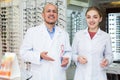 Two ophthalmologists working in optics store