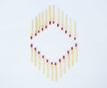 Two opposite directed row of matchsticks arranged as a frame on a white background Royalty Free Stock Photo