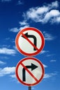 Two opposite road signs against blue sky Royalty Free Stock Photo