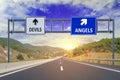 Two options Devils and Angels on road signs on highway Royalty Free Stock Photo