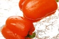 Two orange bell peppers splashing in water Royalty Free Stock Photo