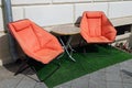 Two orange chairs and a round table for relaxing on the street Royalty Free Stock Photo
