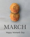 Two orange Dhalia flowers and `March. Happy Women`s day` text in English Royalty Free Stock Photo