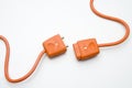 Two Orange Electric Plugs