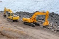 Two orange excavators Royalty Free Stock Photo