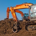 Two orange excavators Royalty Free Stock Photo