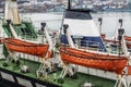 Two orange lifeboats on the ship's davits