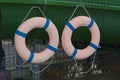 Two orange lifebuoys on hanging on a wooden wall of a boat station photo