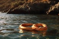 Two orange lifebuoys in open sea. Rescue and safety concept. Emergency equipment for water safety