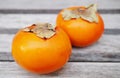 Two orange persimmon kaki fruits