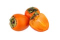 Two orange persimmons fruits or diospyros and one cut off half of persimmon with green leaves on white background isolated closeup Royalty Free Stock Photo