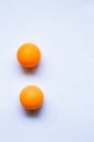 Two orange ping pong balls on white background. Royalty Free Stock Photo