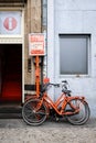 Two orange rental bicycles in Amsterdam