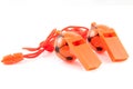 Two orange soccer whistles